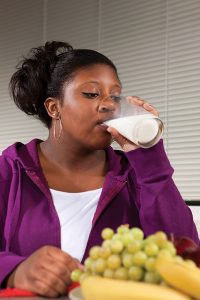 Girl drinking a glass of milk.