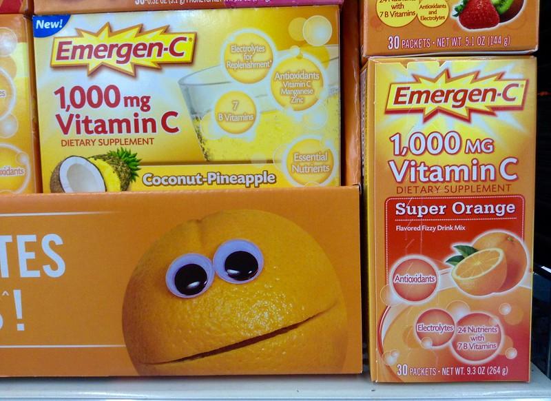 A photograph shows several boxes of Emergen-C dietary supplement, labeled with flavors like super orange and coconut-pineapple and in doses of 1,000 mg of vitamin C.