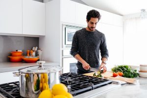 Image of man in kitchen cooking