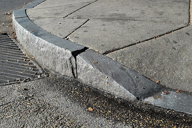 curb cut in sidewalk by storm drain